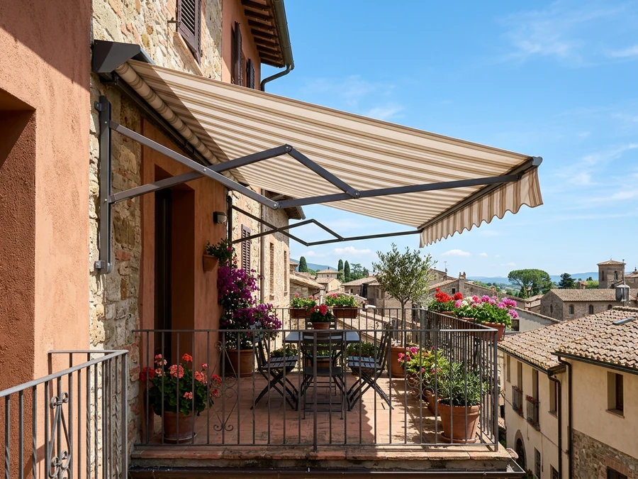 Folding-arm awning extended over a small balcony, articulated arms visible, open sky beyond