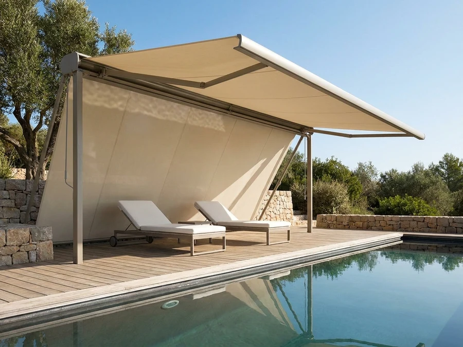 Folding-arm awning extended over a poolside deck, taut fabric canopy shading loungers